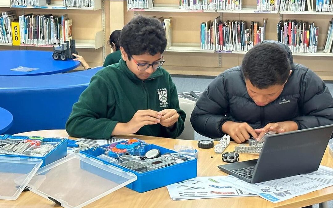 Two kids creating robots